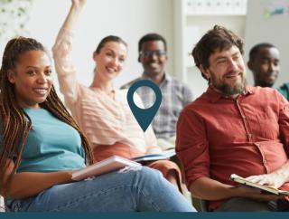 Group of smiling people sitting in a classroom