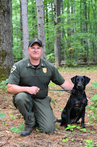 Warden Charles Sawyer and K9 Rain